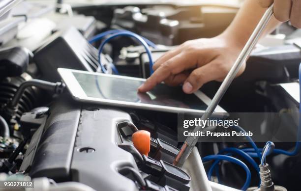 close-up of mechanic with digital tablet - car engine close up stock pictures, royalty-free photos & images