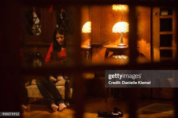 young woman sitting on couch, view through window - katoomba falls stock pictures, royalty-free photos & images