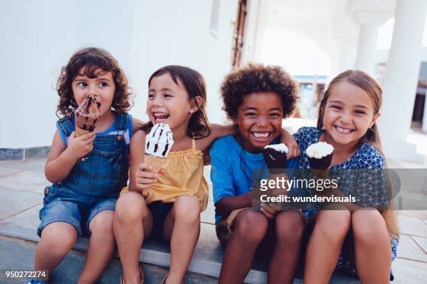 group of cheerful multi-ethnic children eating ice-cream in summer - family eat imagens e fotografias de stock