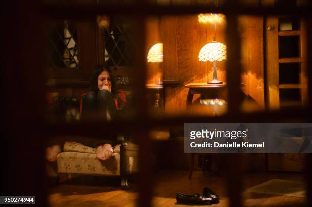 young woman sitting on couch, view through window - katoomba falls stock pictures, royalty-free photos & images