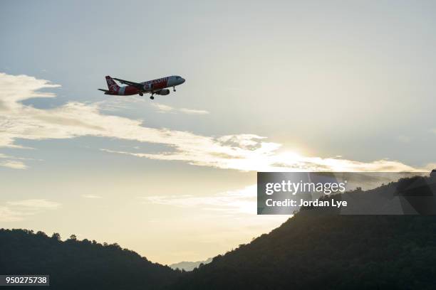 the silhouette of a passenger plane flying in sunset - jordan lye stock pictures, royalty-free photos & images