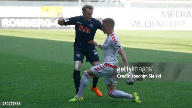 Ben Zolinski of Paderborn challenges Max Dombrowka of Unterhaching during the 3. Liga match between SC Paderborn 07 and SpVgg Unterhaching at...
