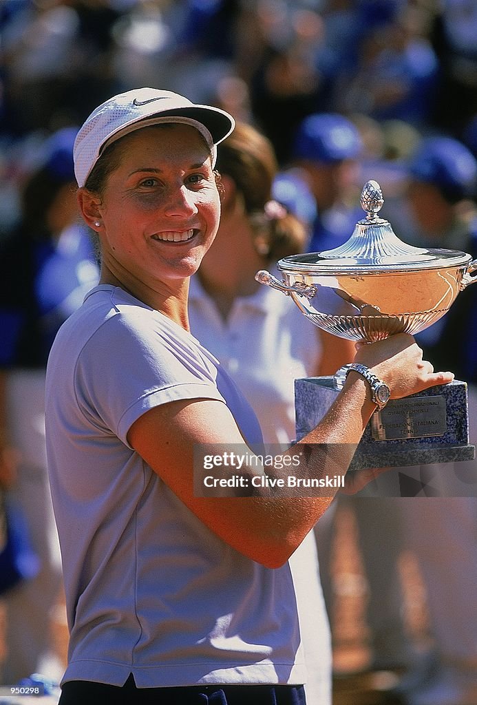 Monica Seles of the USA lifts the trophy after victory in the Italian