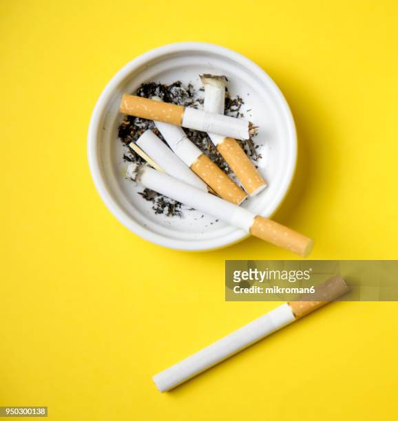 cigarettes and butts in ashtray - aschenbecher stock-fotos und bilder