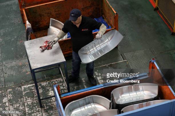 An employee moves aluminium metal at Liberty Pressing Solutions in Coventry, U.K., on Monday, April 23, 2018. Aluminum markets are still reeling from...