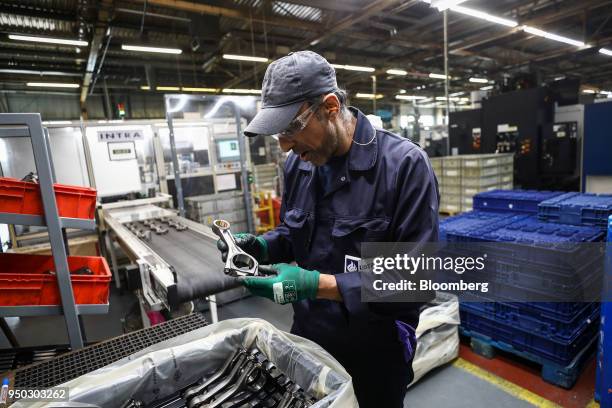 An employee inspects connecting rods at Liberty Aluminium Technologies in Coventry, U.K., on Monday, April 23, 2018. Aluminum markets are still...