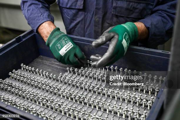 An employee checks screws at Liberty Aluminium Technologies in Coventry, U.K., on Monday, April 23, 2018. Aluminum markets are still reeling from...