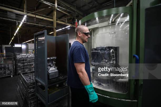 An employee watches as a metal is cut at Liberty Aluminium Technologies in Coventry, U.K., on Monday, April 23, 2018. Aluminum markets are still...