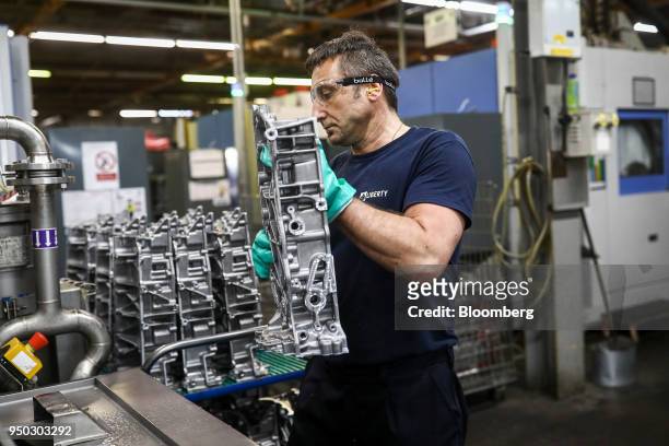 An employee moves a panther ladder frame from a cutting machine at Liberty Aluminium Technologies in Coventry, U.K., on Monday, April 23, 2018....