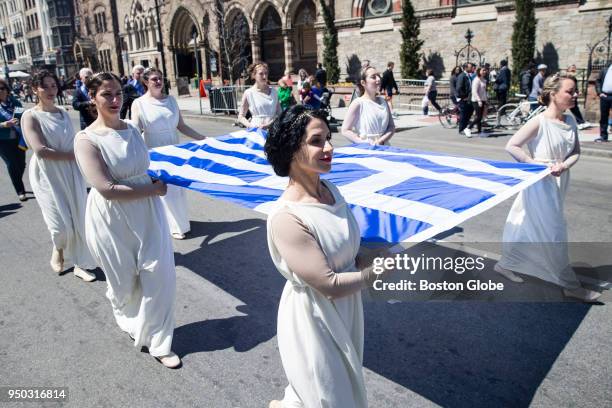 Marchers carry a Greek flag as they take part in the Greek Independence Day Parade on Boylston Street in Boston on April 22, 2018.