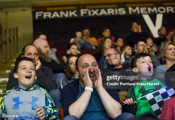 Josh Laverriere of Biddeford cheers with his sons, Noah left, and Keagan as six monster trucks perform during the Traxxas Monster Trucks Destruction...