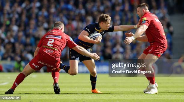 Garry Ringrose of Leinster is tackled by Ken Owens and Rob Evans during the European Rugby Champions Cup Semi-Final match between Leinster Rugby and...