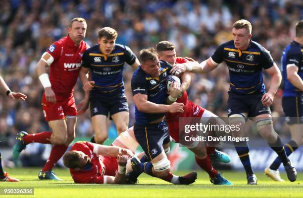 Jordi Murphy of Leinster is tackled by Scott Williams during the European Rugby Champions Cup Semi-Final match between Leinster Rugby and Scarlets at...