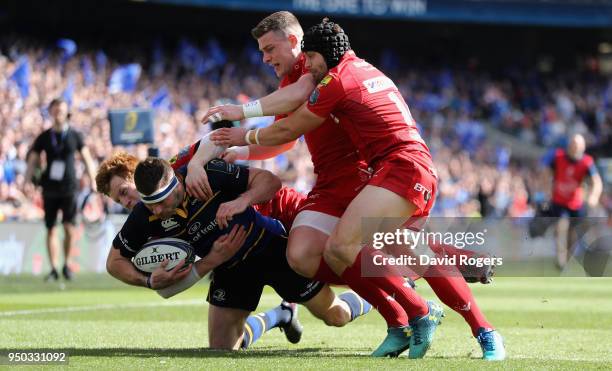 Fergus McFadden of Leinster is tackled by Leigh Halfpenny , Rhys Patchell and Scott Williams during the European Rugby Champions Cup Semi-Final match...