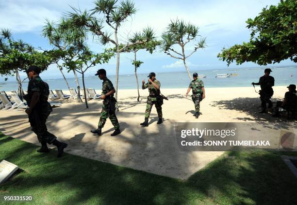 In this photograph taken on November 13, 2011 elite Indonesian marine corps patrols the beach area in Nusa Dua near the venue of the 19th Association...