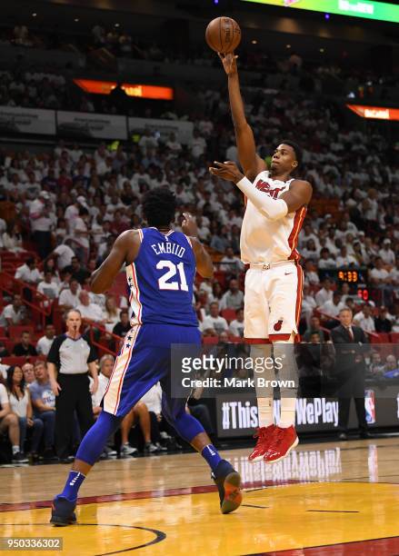 Hassan Whiteside of the Miami Heat shoots over Joel Embiid of the Philadelphia 76ers in the third quarter during Game Four of Round One of the 2018...