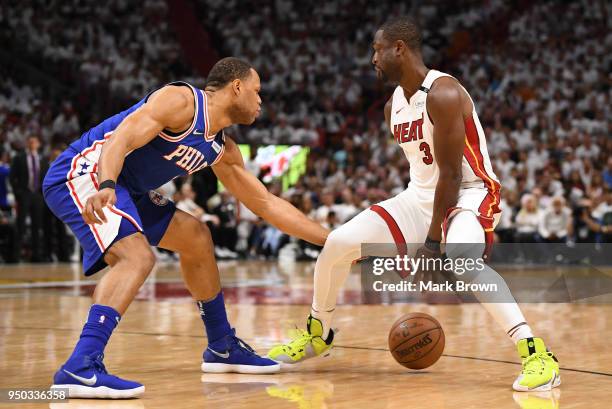 Dwyane Wade of the Miami Heat attempts the cross over dribble against Justin Anderson of the Philadelphia 76ers in the third quarter during Game Four...