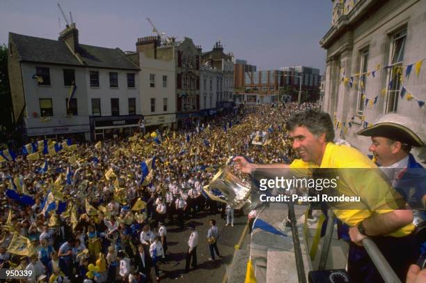 Wimbledon Manager Bobby Gould shows off the trophy to the fans in Wimbledon after their victory over Liverpool in the FA Cup Final at Wembley Stadium...