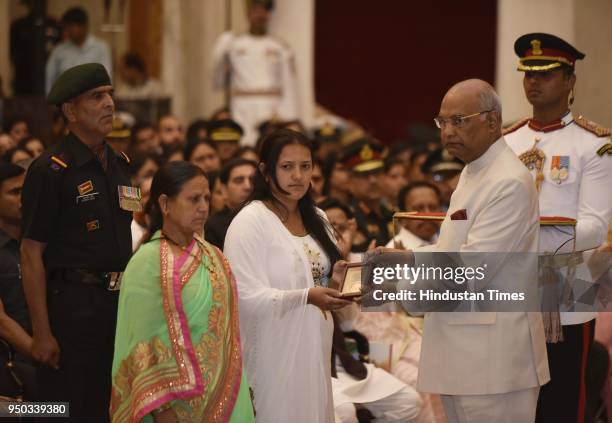 Wife of Lance Naik Raghubeer Singh, The Mahar Regiment, 1st Battalion Rashtriya Rifles, receives Shaurya Chakra from President Ram Nath Kovind as...