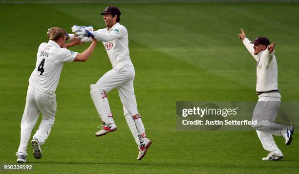 Matt Dunn of Surrey celebrates taking the final wicket with Ben Foakes after dismissing Sam Northeast of Hampshire during the Specsavers County...