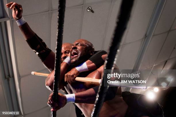 Professional wrestler Derrick Green Jr. , better known by his ring name Napalm Bomb, is choked out with a bamboo stick by Drolix during the Tribute...