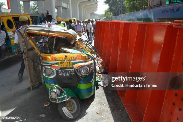 Car and an auto-rickshaw were crushed after the girder fell on them, which was being used by the Delhi Metro for the construction of a foot-over...