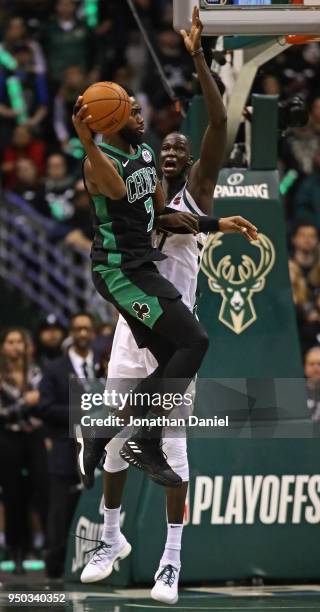 Jaylen Brown of the Boston Celtics leaps to pass under pressure from Thon Maker of the Milwaukee Bucks during Game Four of Round One of the 2018 NBA...