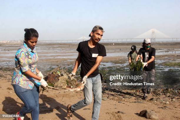 Volunteers participate in beach cleanup and tree plantation drive on the occasion of World Earth Day, at Dadar Chowpatty, on April 22, 2018 in...