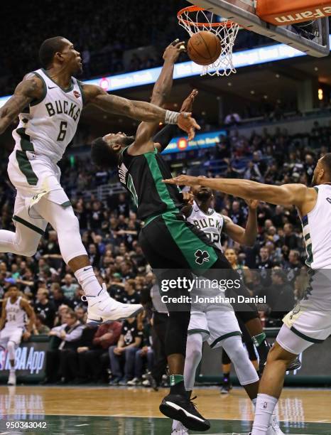 Jaylen Brown of the Boston Celtics tries to get off a shot under pressure from Eric Bledsoe, Khris Middleton and Jabari Parker of the Milwaukee Bucks...