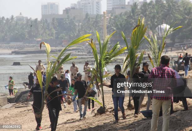 Volunteers participate in beach cleanup and tree plantation drive on the occasion of World Earth Day, at Dadar Chowpatty, on April 22, 2018 in...