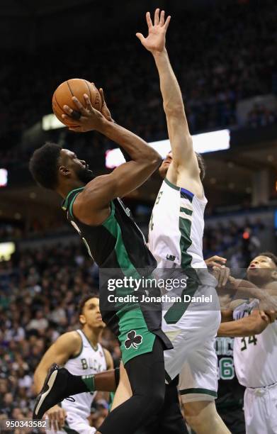 Jaylen Brown of the Boston Celtics tries to get off a shot against Tyler Zeller of the Milwaukee Bucks during Game Four of Round One of the 2018 NBA...