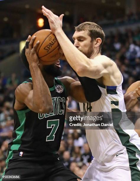 Tyler Zeller of the Milwaukee Bucks gets his arm on the ball as Jaylen Brown of the Boston Celtics drives during Game Four of Round One of the 2018...