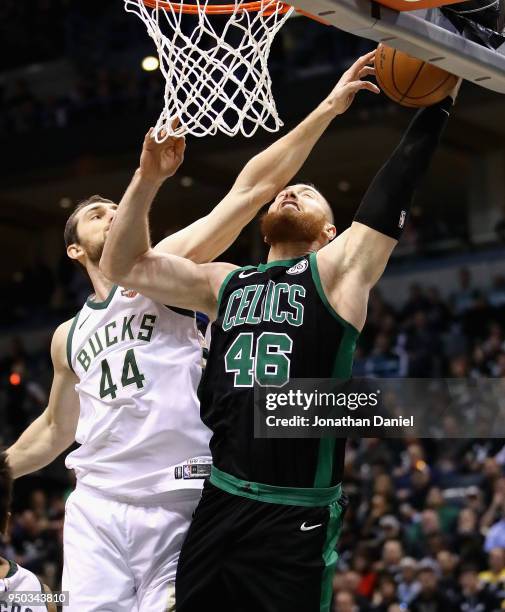 Tyler Zeller of the Milwaukee Bucks blocks a shot by Aron Baynes of the Boston Celtics but gets called for a foul during Game Four of Round One of...