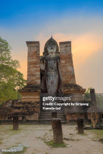 the standing buddha statue of wat mahathat inside the sukhothai historical park, sukhothai province, thailand. - copyright by siripong kaewla iad stock pictures, royalty-free photos & images