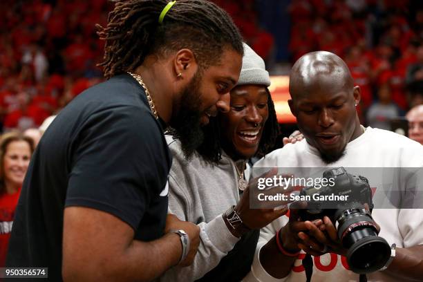 New Orleans Saints Players Cameron Jordan, Alvin Kamara and Chris Banjo look at a camera while attending Game 3 of the Western Conference playoffs...