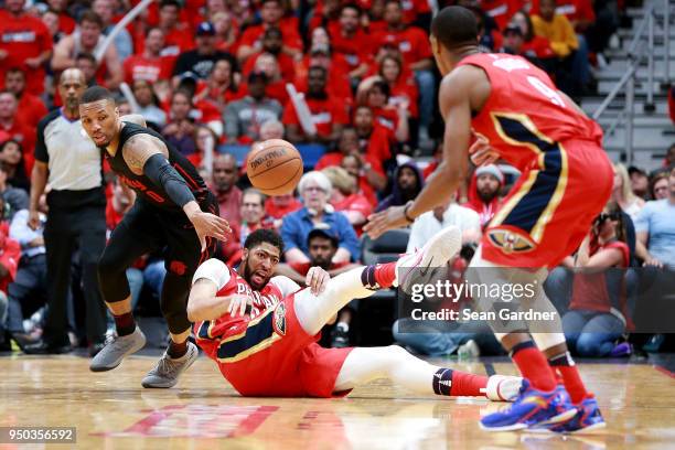 Anthony Davis of the New Orleans Pelicans steals the ball from Damian Lillard of the Portland Trail Blazers during Game 3 of the Western Conference...