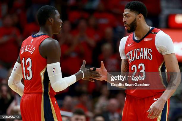 Anthony Davis of the New Orleans Pelicans and Cheick Diallo of the New Orleans Pelicans react after scoring against the Portland Trail Blazers during...