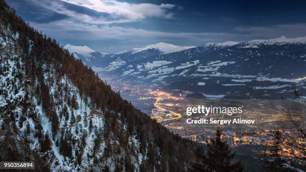 aerial view of innsbruck at night - österreich winter stock-fotos und bilder