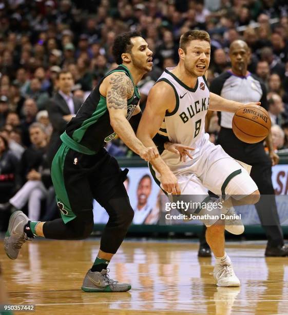 Matthew Dellavedova of the Milwaukee Bucks drives past Shane Larkin of the Boston Celtics during Game Four of Round One of the 2018 NBA Playoffs at...