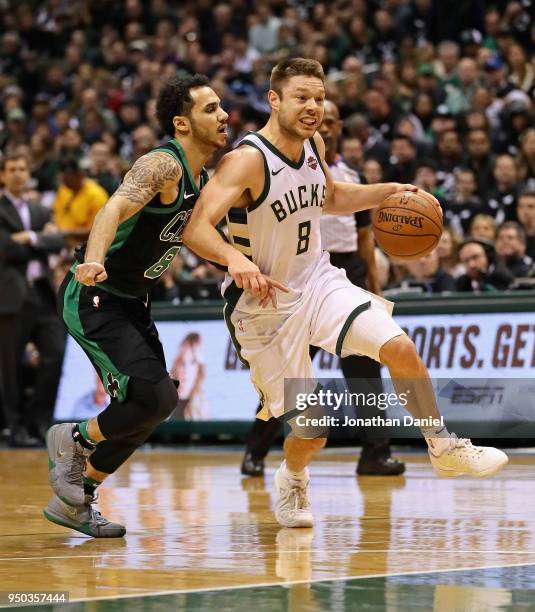 Matthew Dellavedova of the Milwaukee Bucks drives past Shane Larkin of the Boston Celtics during Game Four of Round One of the 2018 NBA Playoffs at...