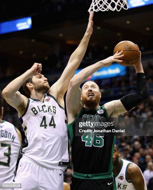 Aron Baynes of the Boston Celtics goes up for a shot against Tyler Zeller of the Milwaukee Bucks during Game Four of Round One of the 2018 NBA...