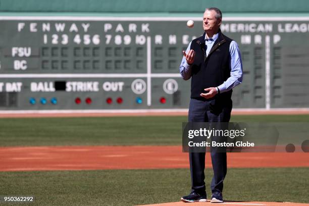 Massachusetts Governor Charlie Baker throws out the ceremonial first pitch before the start of the 7th Annual ALS Awareness game between Boston...