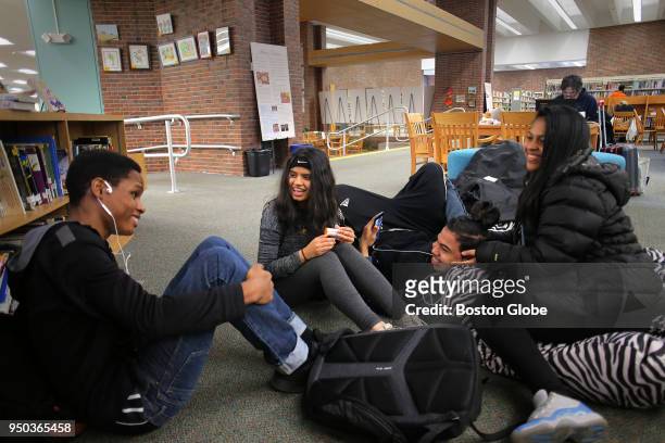 From left, Kai Cater Humaira Chowdhury Christofer Martinez and Naay Maggiolo lounge after school at the Coolidge Corner Library in the Coolidge...
