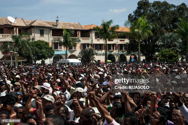 Opposition supporters shout slogans as they gather at "May 13 Square" in Antananarivo on April 23 to offer their condolences to the families of...