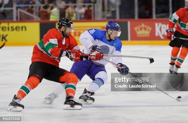 Janos Vas of Hungary challenges Pavel Akolzin of Kazakhstan during the 2018 IIHF Ice Hockey World Championship Division I Group A match between...