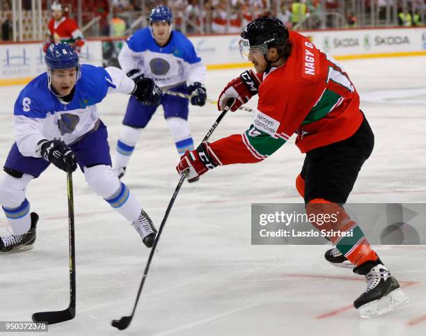 Gergo Nagy of Hungary shoots on goal next to Anton Sagadeyev of Kazakhstan during the 2018 IIHF Ice Hockey World Championship Division I Group A...