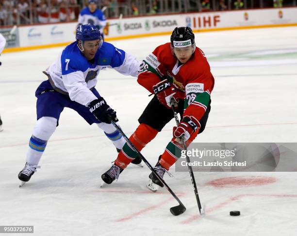 Maxim Semyonov of Kazakhstan challenges Csanad Erdely of Hungary during the 2018 IIHF Ice Hockey World Championship Division I Group A match between...