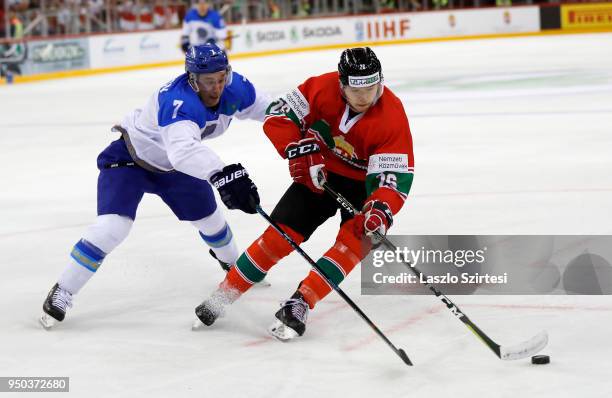 Maxim Semyonov of Kazakhstan challenges Csanad Erdely of Hungary during the 2018 IIHF Ice Hockey World Championship Division I Group A match between...