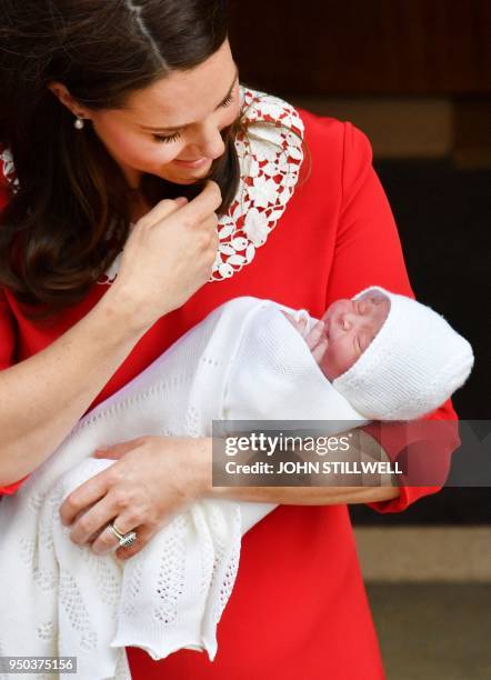 Britain's Catherine, Duchess of Cambridge aka Kate Middleton holds her newly-born son, her third child, Britain's Prince Louis of Cambridge as she...