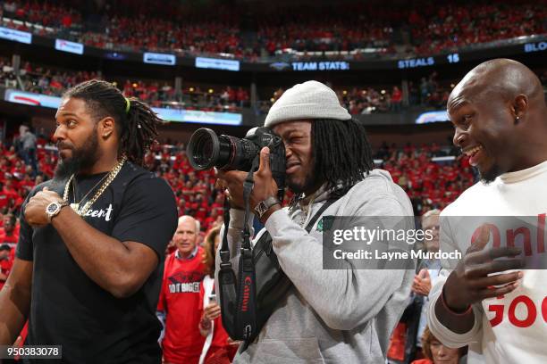 New Orleans Saints players Cameron Jordan, Alvin Kamara, and Chris Banjo attend Game Three of Round One between the Portland Trail Blazers and the...